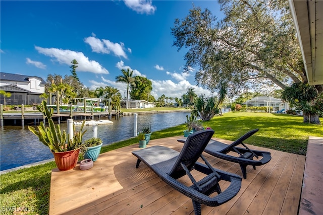 deck featuring a boat dock, a lawn, a water view, and glass enclosure