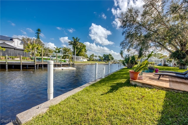 view of dock featuring a yard and a water view