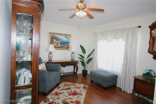 sitting room with dark hardwood / wood-style floors and ceiling fan