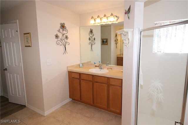 bathroom with vanity, an enclosed shower, and tile patterned flooring