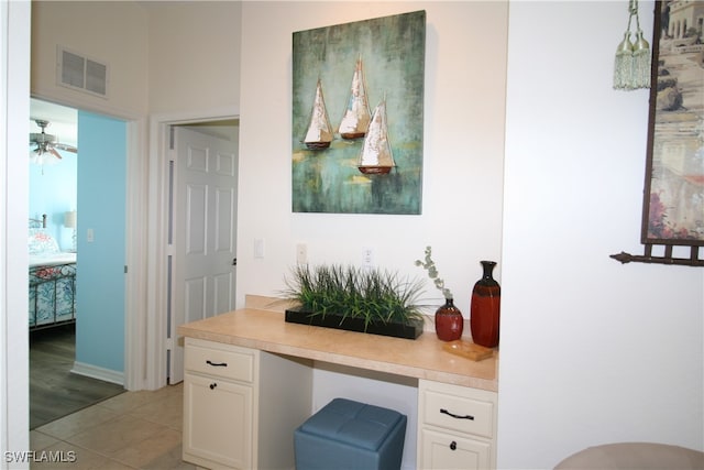 interior space featuring built in desk and ceiling fan