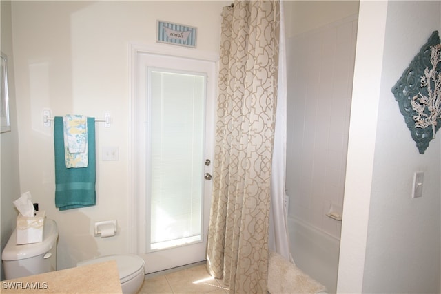 bathroom with toilet, shower / tub combo with curtain, and tile patterned flooring