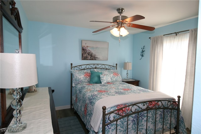 bedroom with dark wood-type flooring and ceiling fan