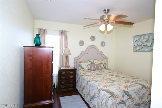 bedroom featuring dark hardwood / wood-style flooring and ceiling fan