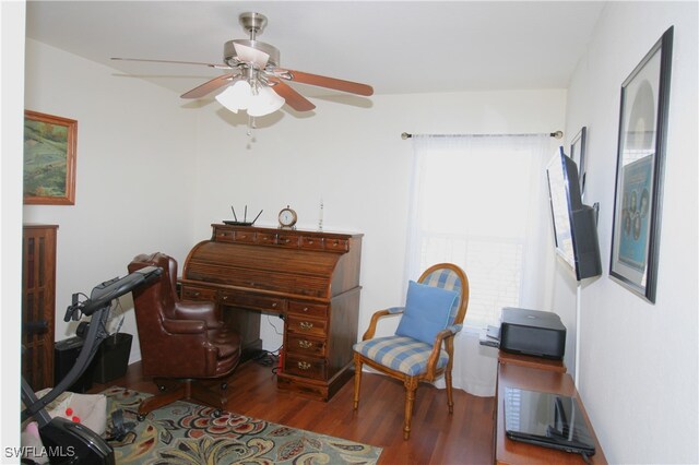 sitting room with hardwood / wood-style floors and ceiling fan