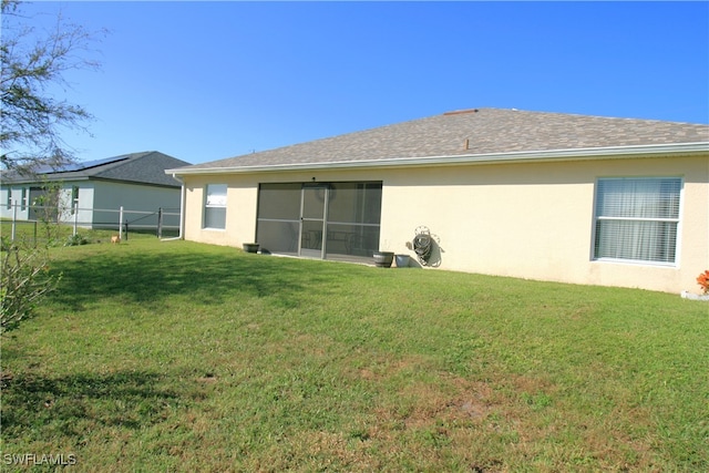 rear view of property with a yard