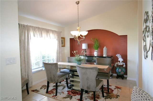 dining area with a notable chandelier and light tile patterned floors