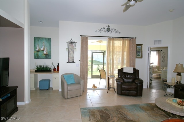 living room with ceiling fan, light tile patterned floors, and plenty of natural light