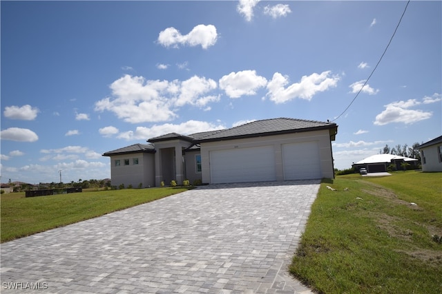 view of front of property featuring a front yard and a garage