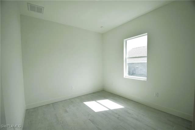 spare room with light wood-type flooring