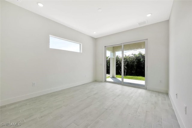 unfurnished room featuring light wood-style floors, recessed lighting, and baseboards