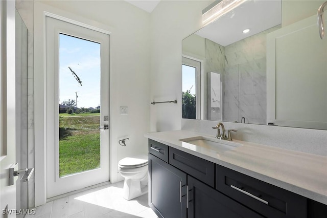 full bath featuring a marble finish shower, vanity, and toilet