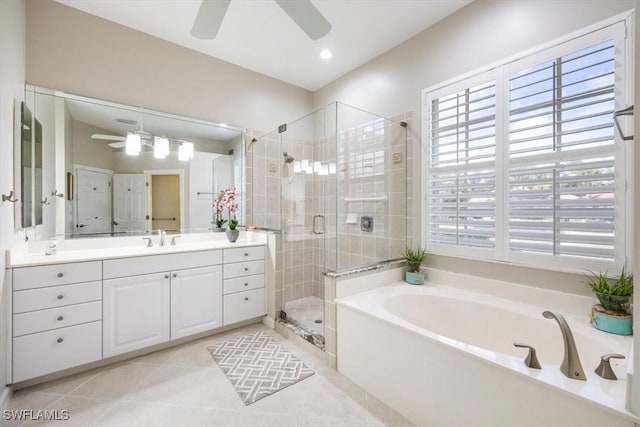 bathroom featuring ceiling fan, a bath, tile patterned flooring, a shower stall, and vanity