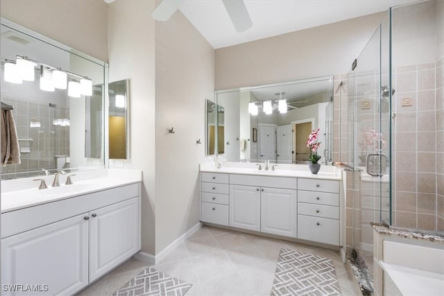 bathroom with tile patterned flooring, vanity, ceiling fan, and a shower with door