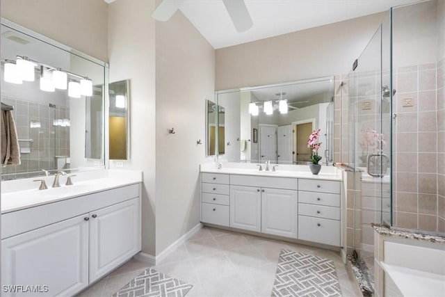 full bath featuring a sink, tile patterned floors, a stall shower, and two vanities