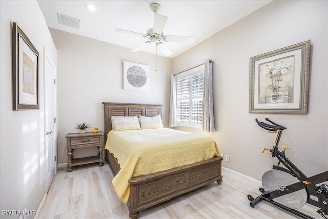 bedroom with visible vents, a ceiling fan, baseboards, and wood finished floors