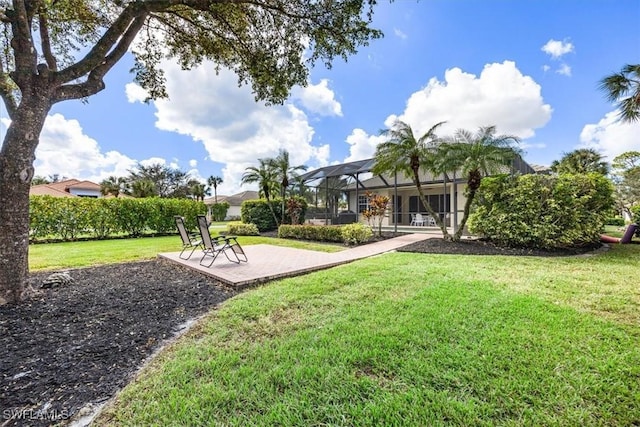 16213 Parque Ln, Naples, FL 34110 - view of grassy yard with a lanai and a patio area