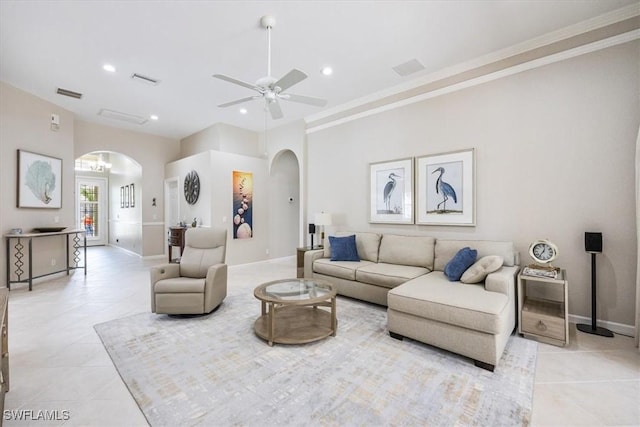 living room with ceiling fan, light tile patterned flooring, and ornamental molding