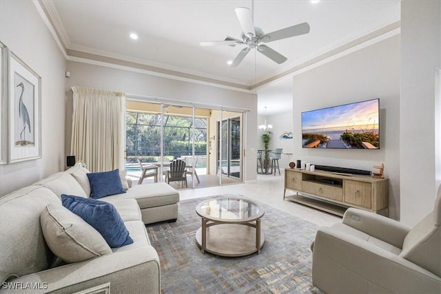 living room featuring tile patterned flooring, ceiling fan with notable chandelier, and ornamental molding