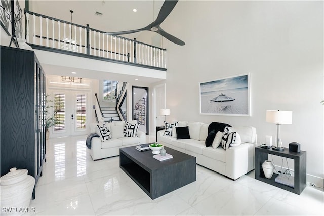 1045 Cottonwood Ct, Marco Island, FL 34145 - living room with marble tiled flooring, stairs, ceiling fan, french doors, and a chandelier