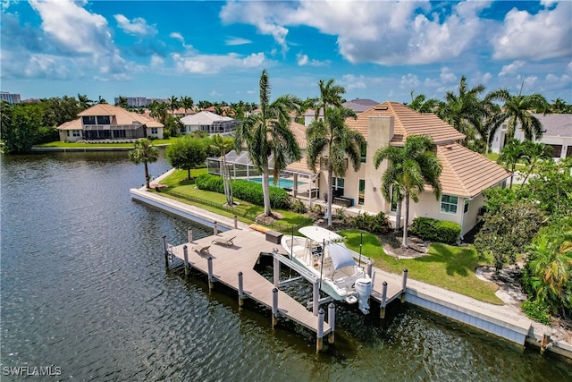 view of dock with a water view and a yard