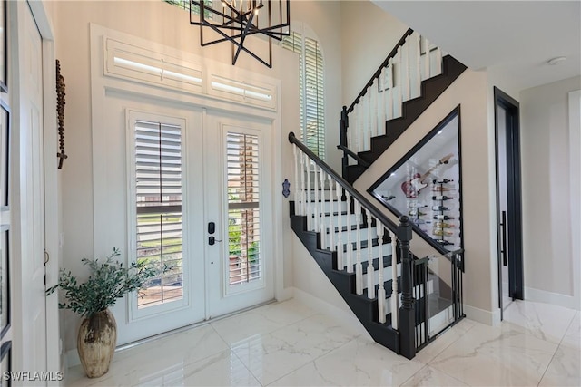 1045 Cottonwood Ct, Marco Island, FL 34145 - foyer featuring french doors, marble look tiles, stairway, and baseboards