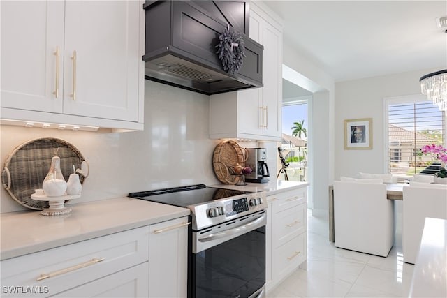 kitchen with custom range hood, electric range, a notable chandelier, decorative light fixtures, and white cabinets