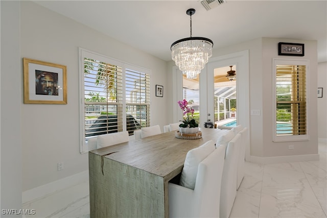 dining room with ceiling fan with notable chandelier