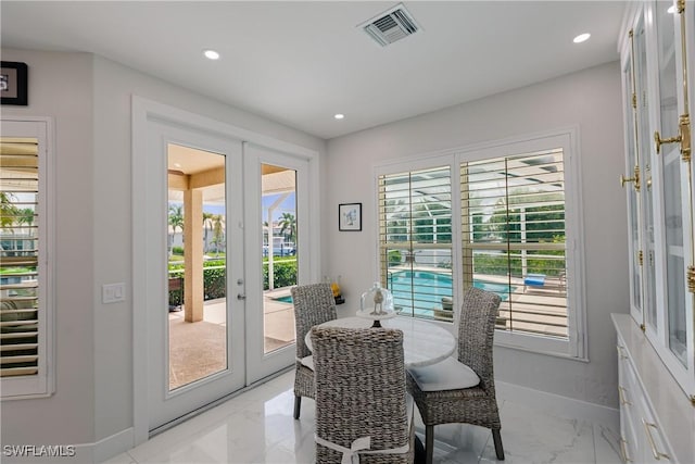 1045 Cottonwood Ct, Marco Island, FL 34145 - dining area with french doors, light marble finish flooring, baseboards, and recessed lighting