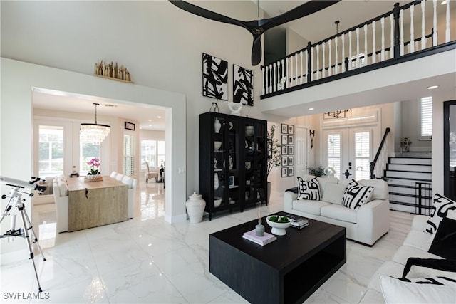 1045 Cottonwood Ct, Marco Island, FL 34145 - living room with french doors, light marble finish floors, a chandelier, a high ceiling, and baseboards