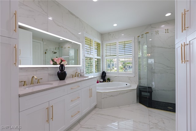 bathroom featuring vanity and shower with separate bathtub