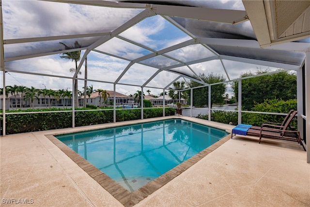 view of swimming pool with a patio area and glass enclosure