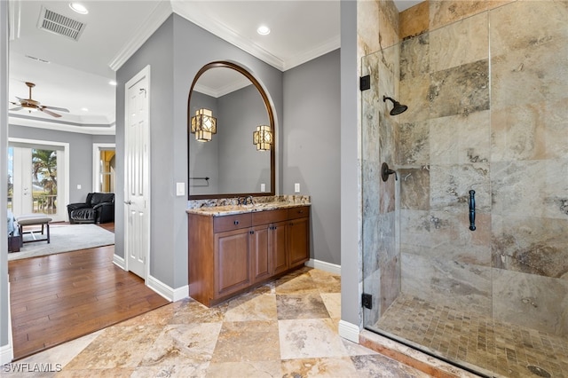 bathroom with crown molding, walk in shower, vanity, hardwood / wood-style flooring, and ceiling fan