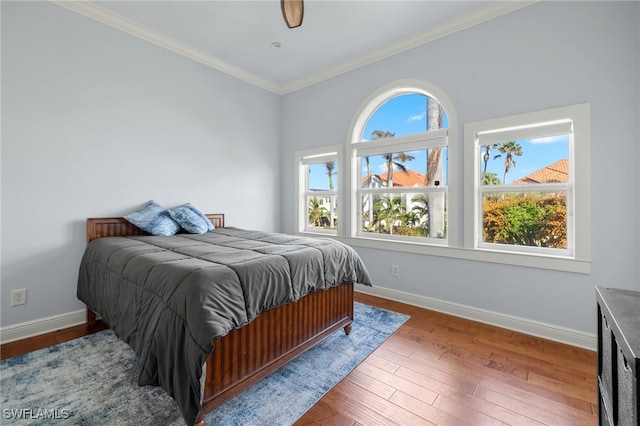 bedroom with wood-type flooring and ornamental molding