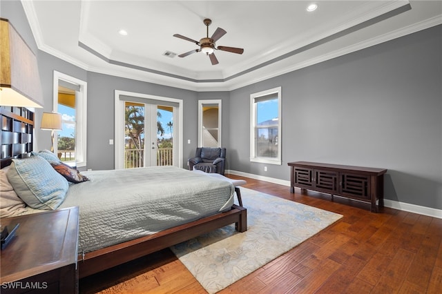 bedroom featuring ceiling fan, a raised ceiling, crown molding, dark wood-type flooring, and access to outside