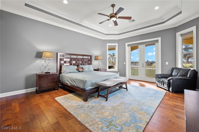 bedroom with ornamental molding, ceiling fan, access to exterior, hardwood / wood-style floors, and a raised ceiling