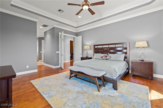 bedroom featuring ceiling fan, dark hardwood / wood-style floors, and ornamental molding