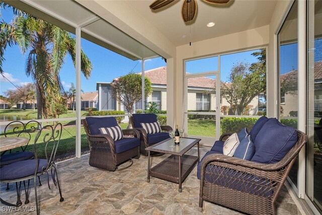 sunroom featuring ceiling fan