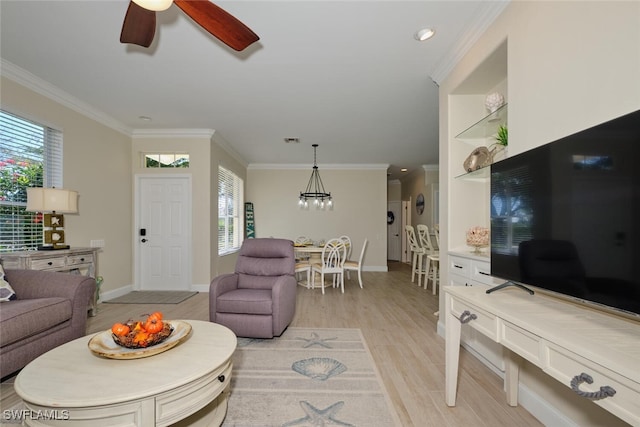 living room featuring crown molding, ceiling fan with notable chandelier, and light wood-type flooring