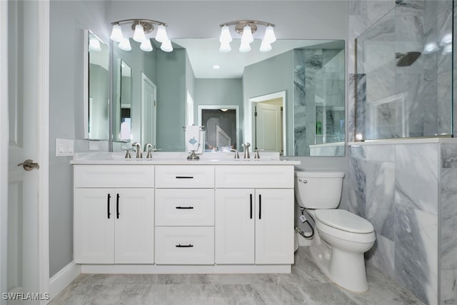 bathroom with toilet, vanity, and a shower with door