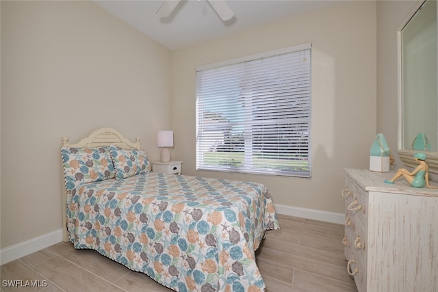 bedroom with light hardwood / wood-style flooring and ceiling fan