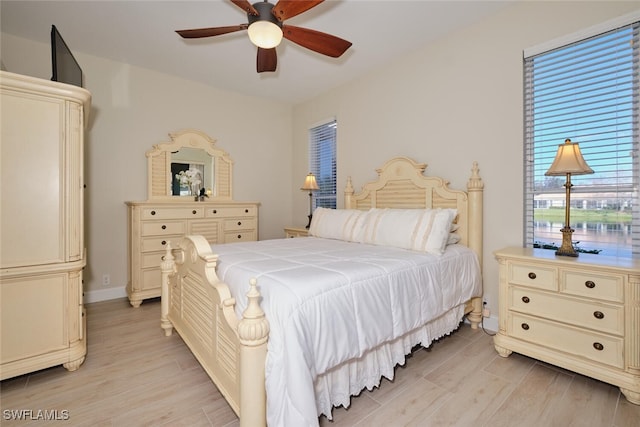 bedroom with light hardwood / wood-style floors and ceiling fan