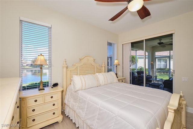 bedroom featuring a closet, light hardwood / wood-style flooring, access to exterior, and ceiling fan