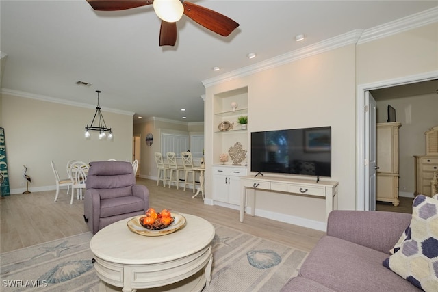 living room with ornamental molding, ceiling fan with notable chandelier, and light wood-type flooring