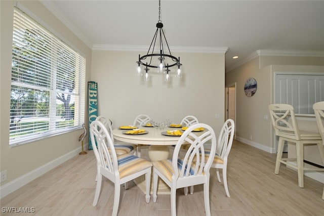 dining area featuring light hardwood / wood-style flooring, ornamental molding, and a notable chandelier