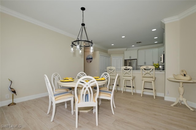 dining room with crown molding, a chandelier, and light wood-type flooring