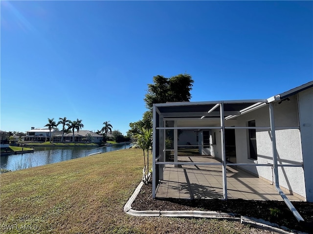 view of yard featuring a water view and a lanai