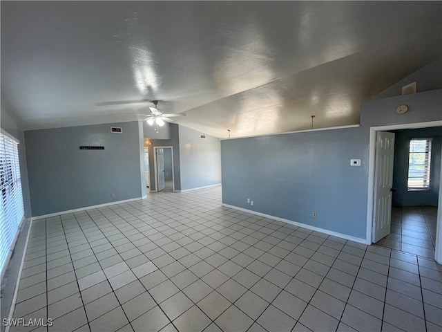 tiled empty room featuring ceiling fan and vaulted ceiling