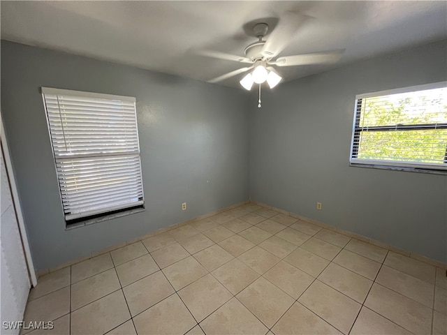 spare room featuring ceiling fan and light tile patterned floors