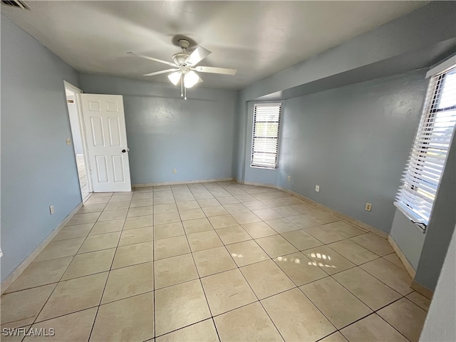 tiled empty room with ceiling fan